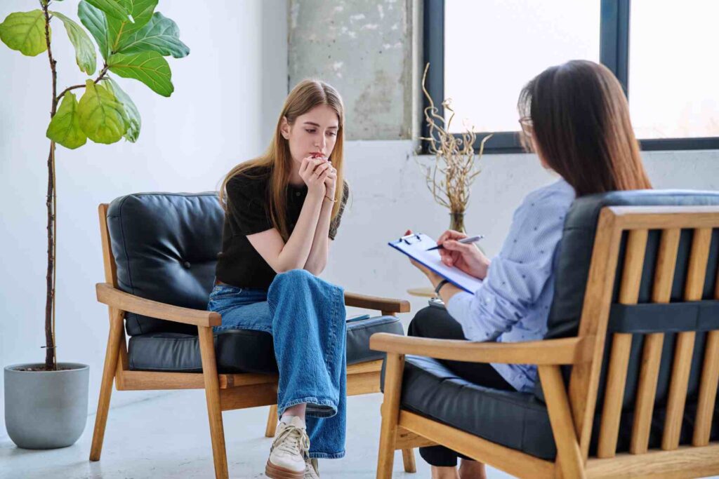 Therapist meeting with young adult to discuss addiction treatment options