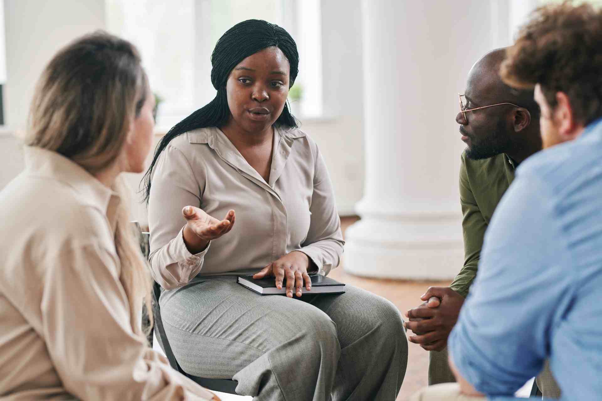 Group therapy session for addiction treatment with therapist and participants
