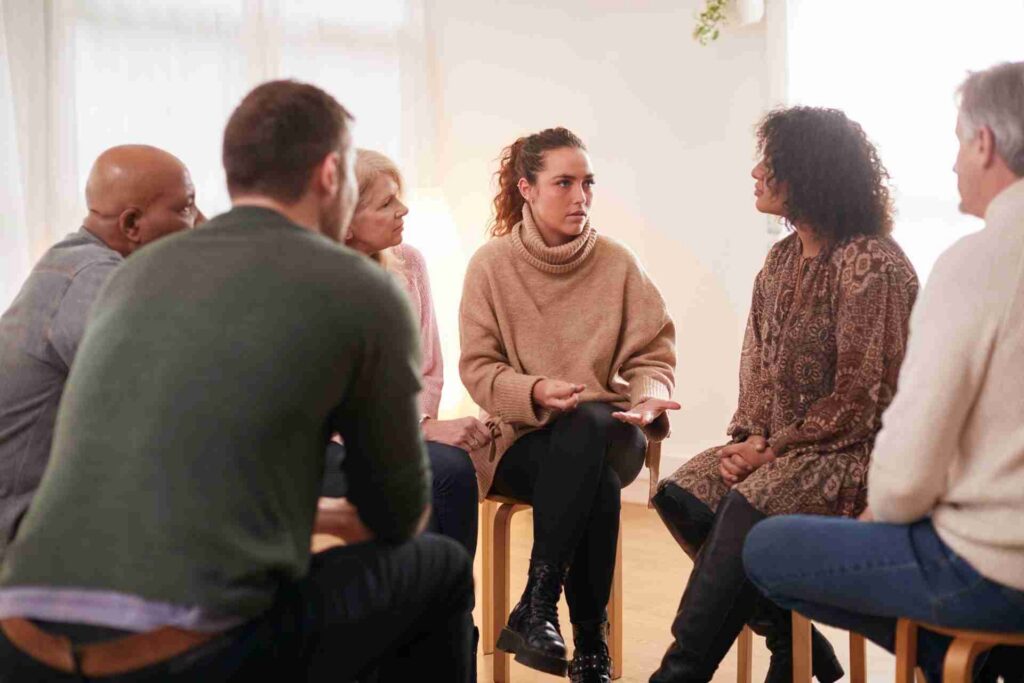 People participating in a group addiction recovery session during treatment